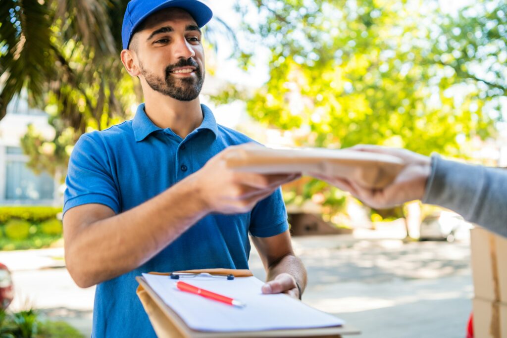 Delivery man making home delivery to customer.